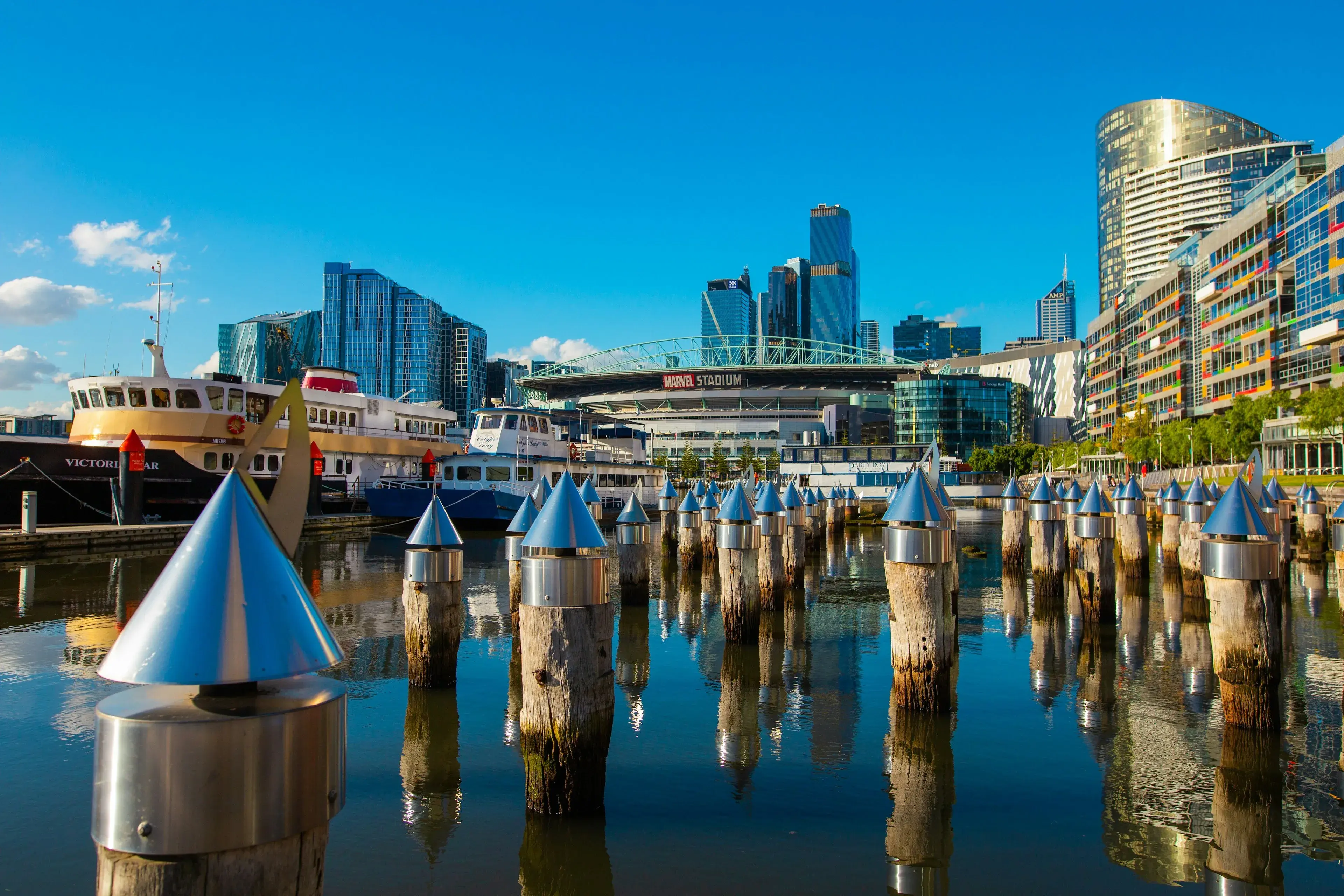Harbour-side towers, ferries and timber pylons on a clear day