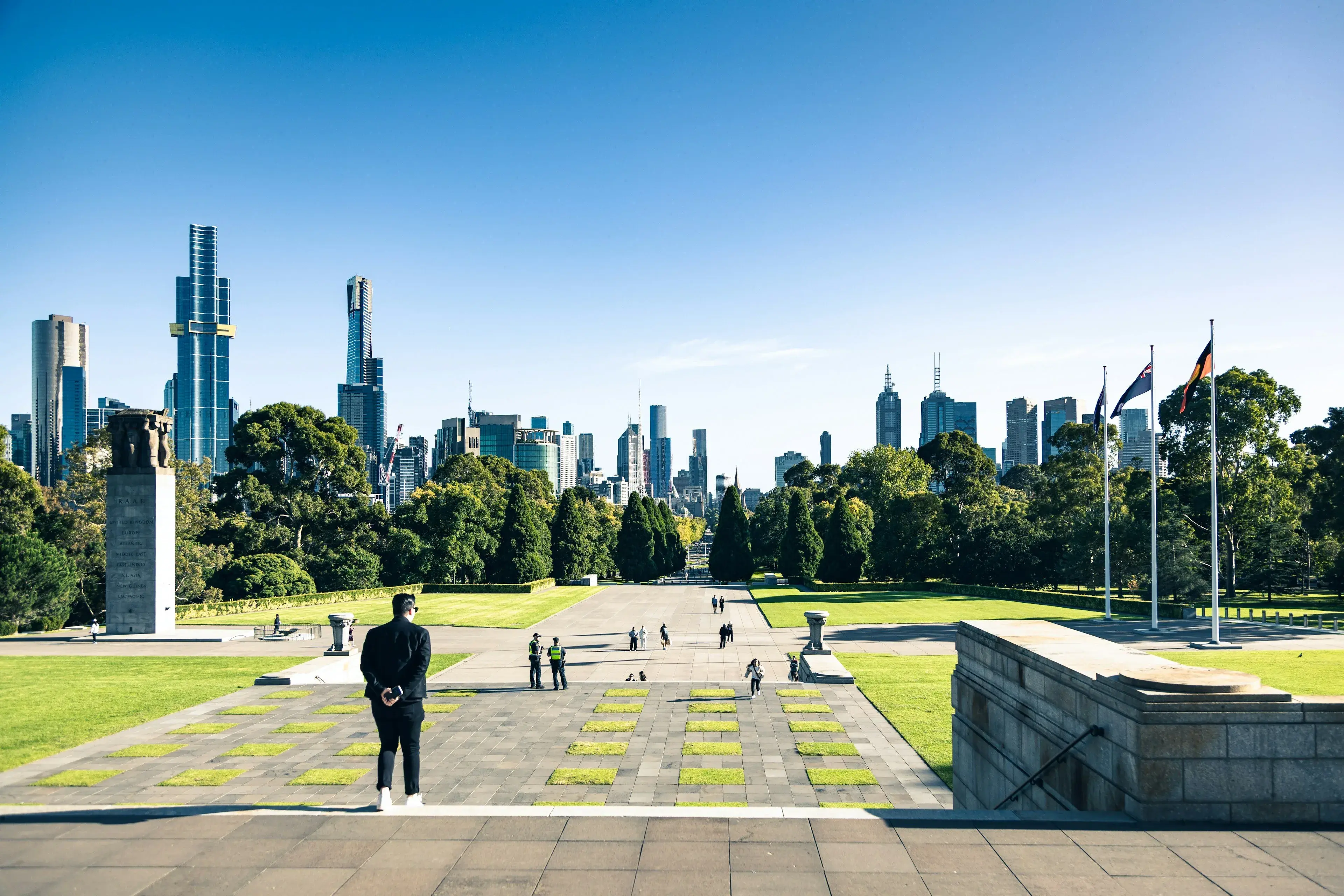 A person looking across parkland towards the Melbourne skyline