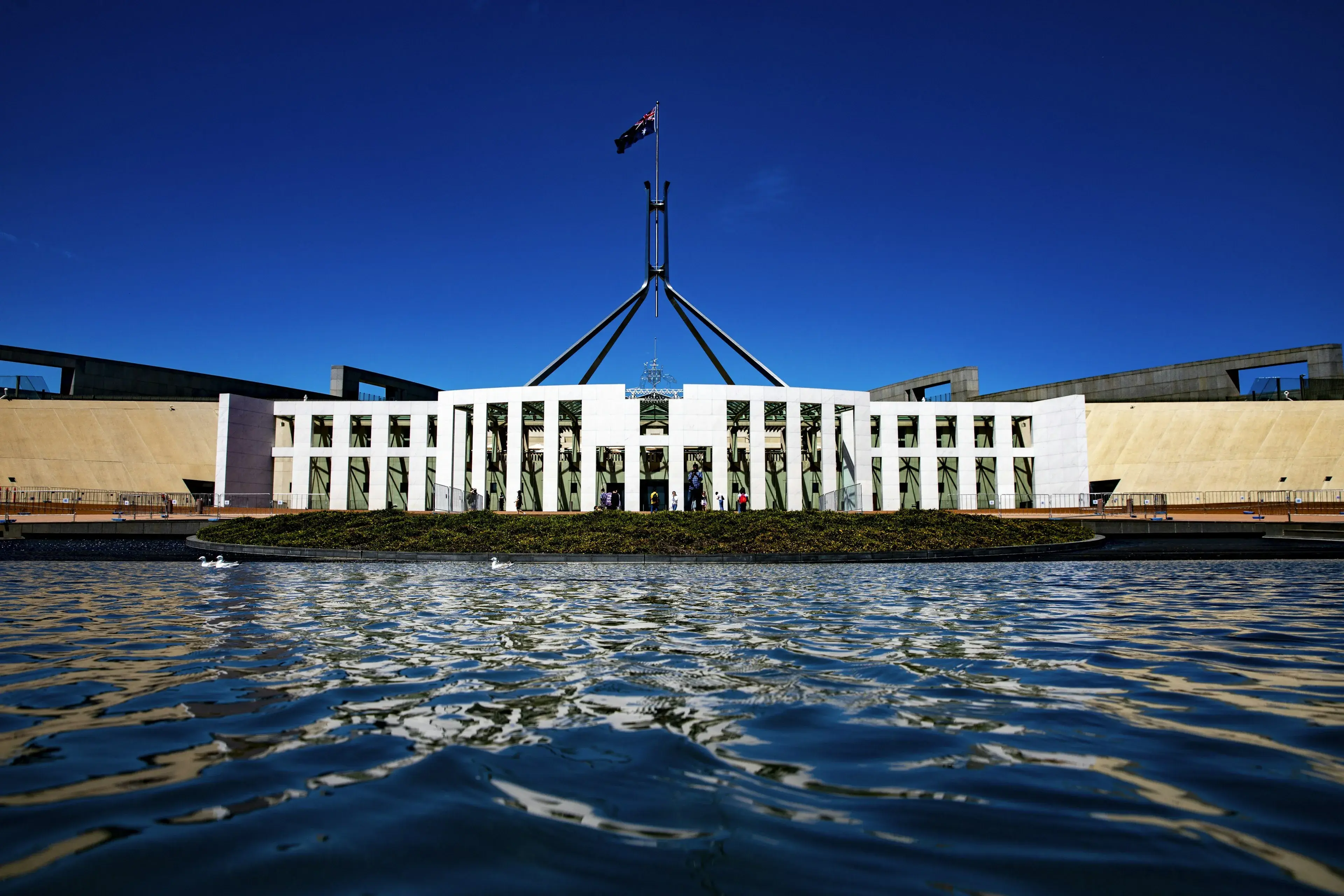 Parliament House in Canberra under a deep blue sky