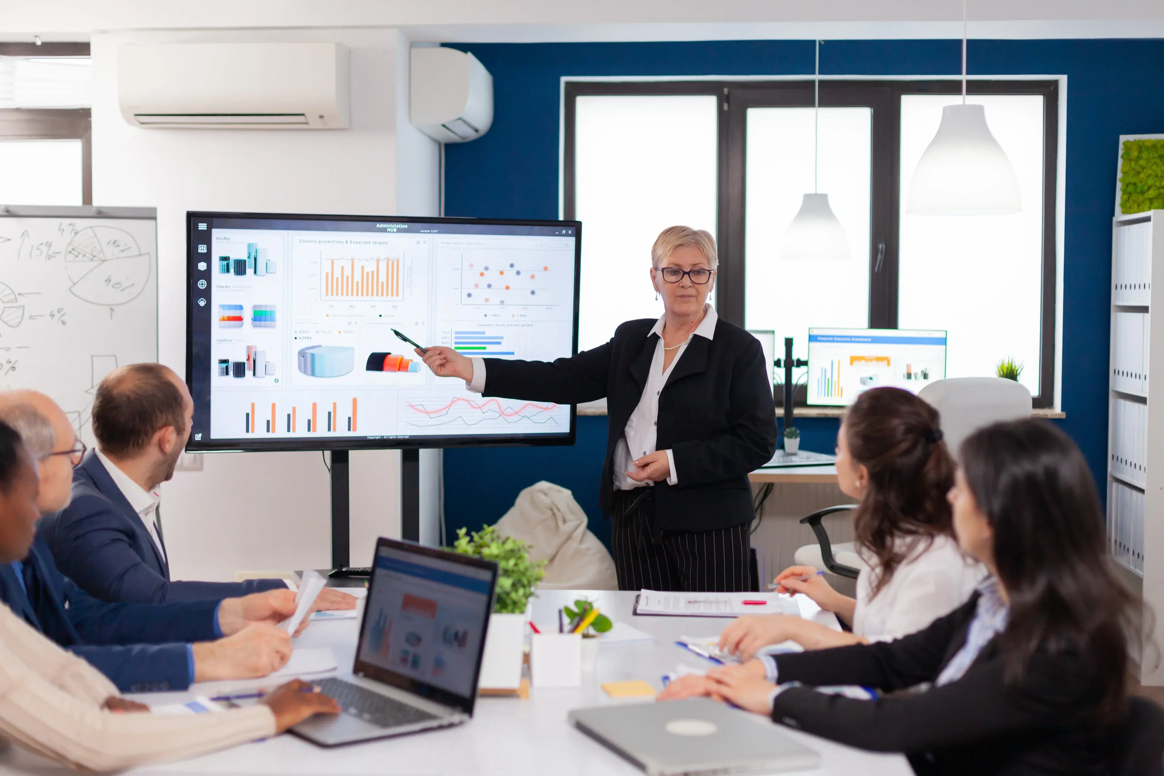A senior leader and her team reviewing a new application on screen