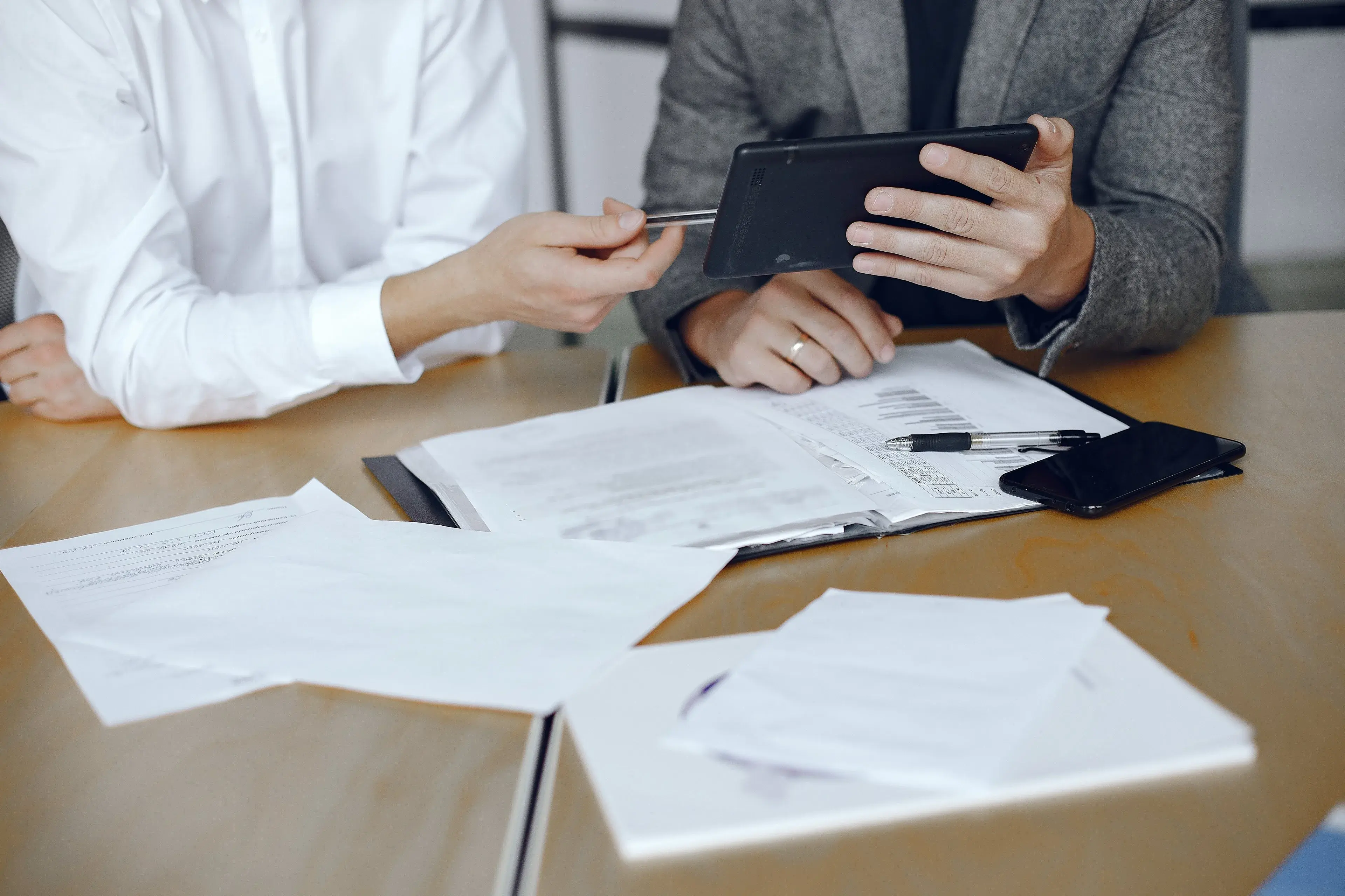 Clients signing documents across a desk