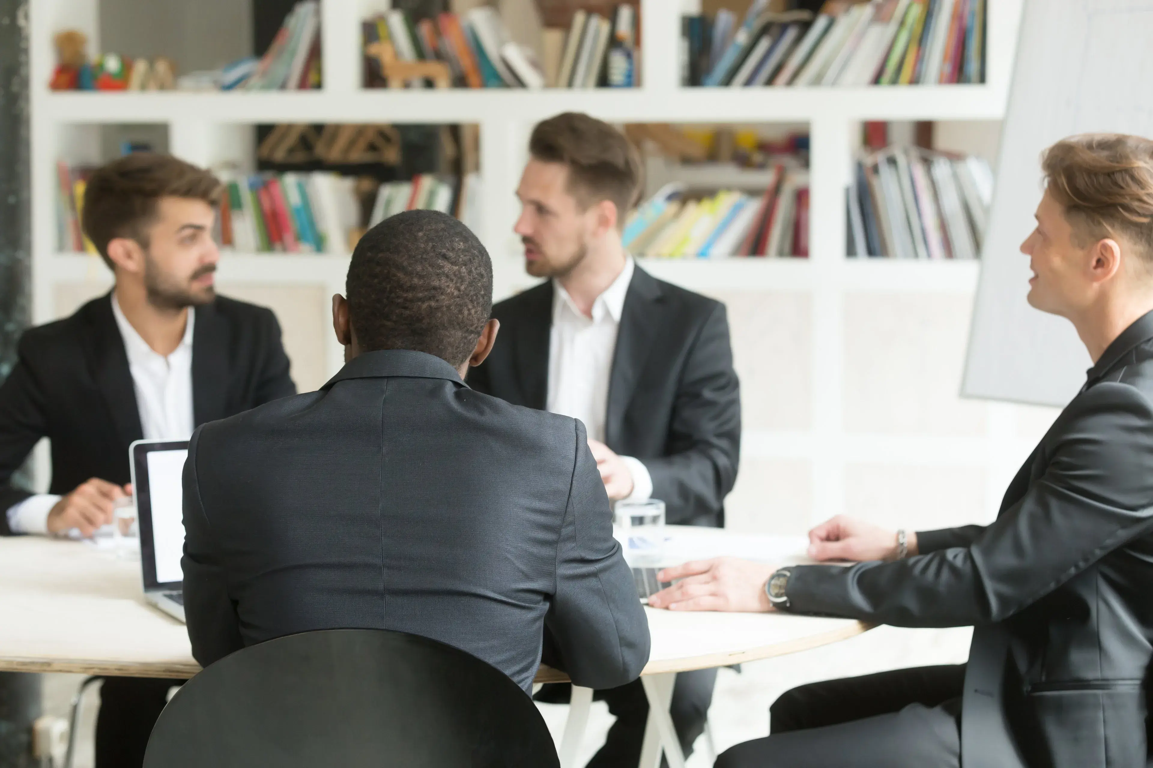 A small team meeting around a table in an office