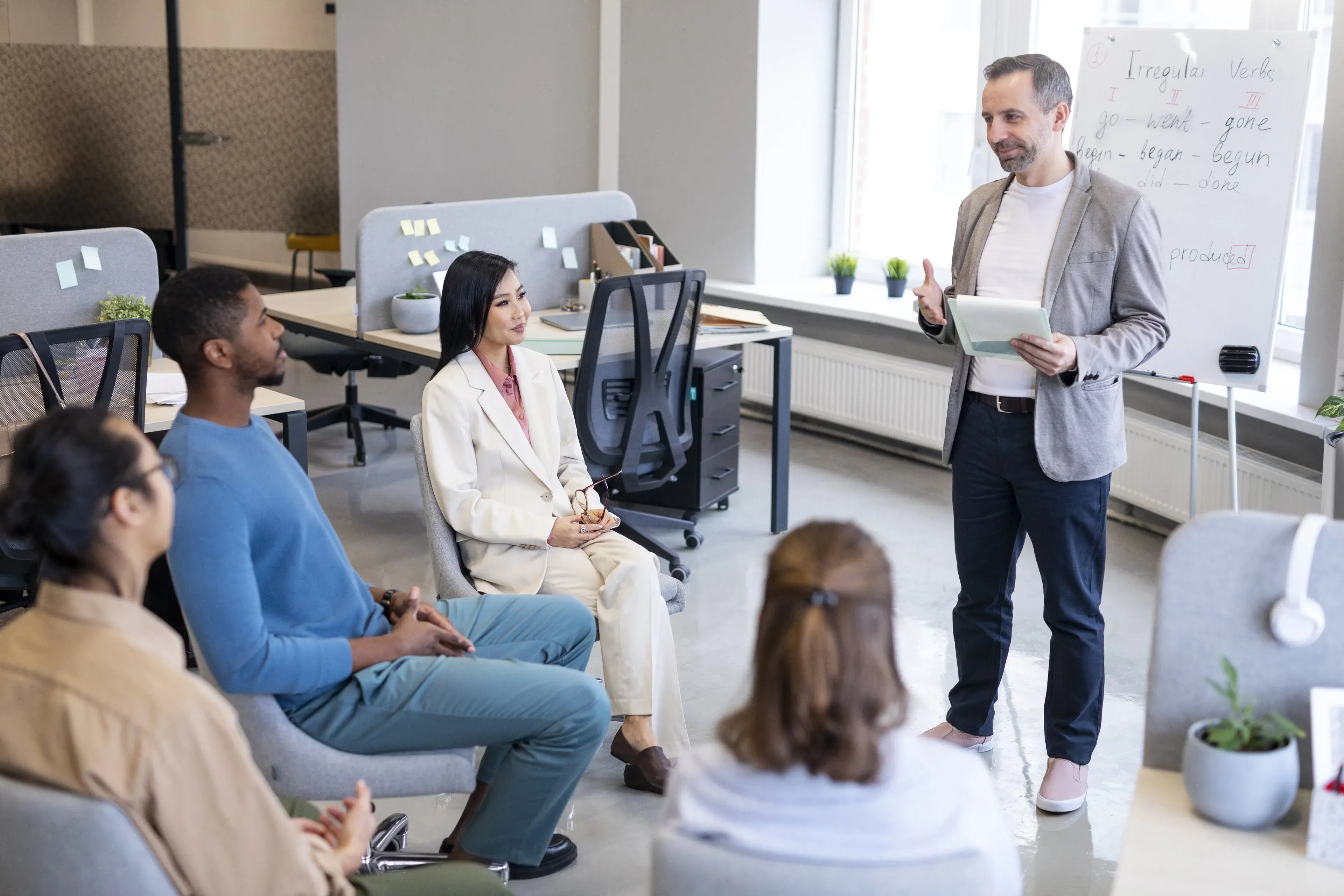 A trainer leading a small staff session in an office