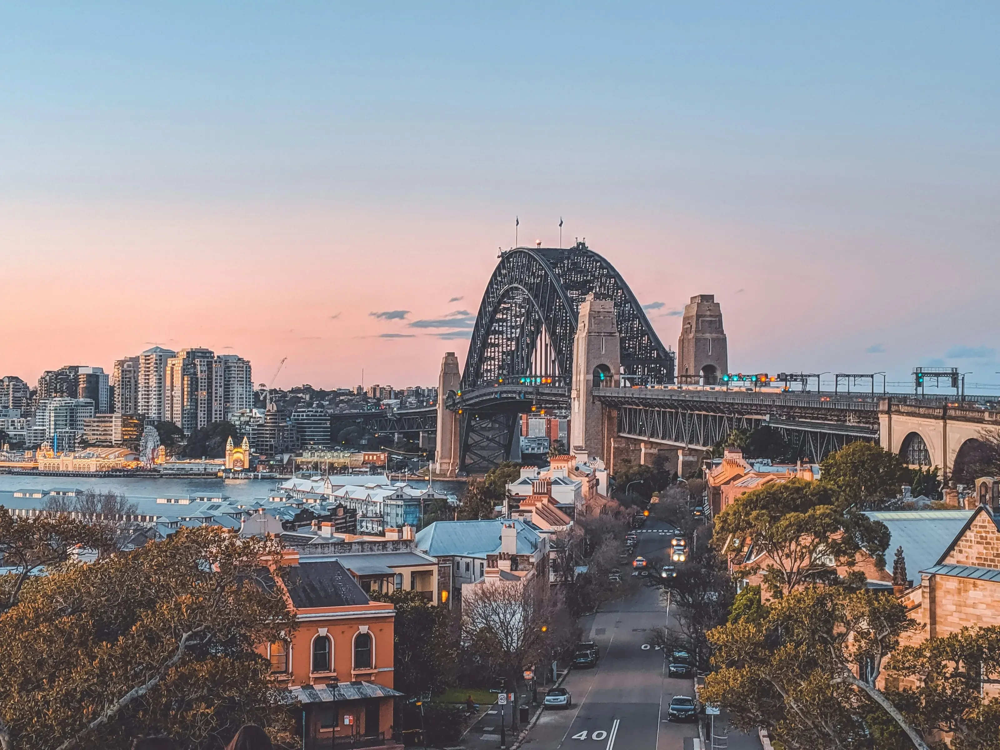 Sydney Harbour Bridge and city buildings at dusk