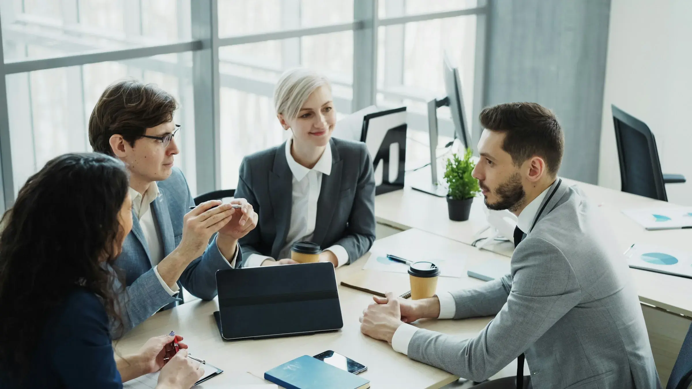 A client-service team working together in a modern office