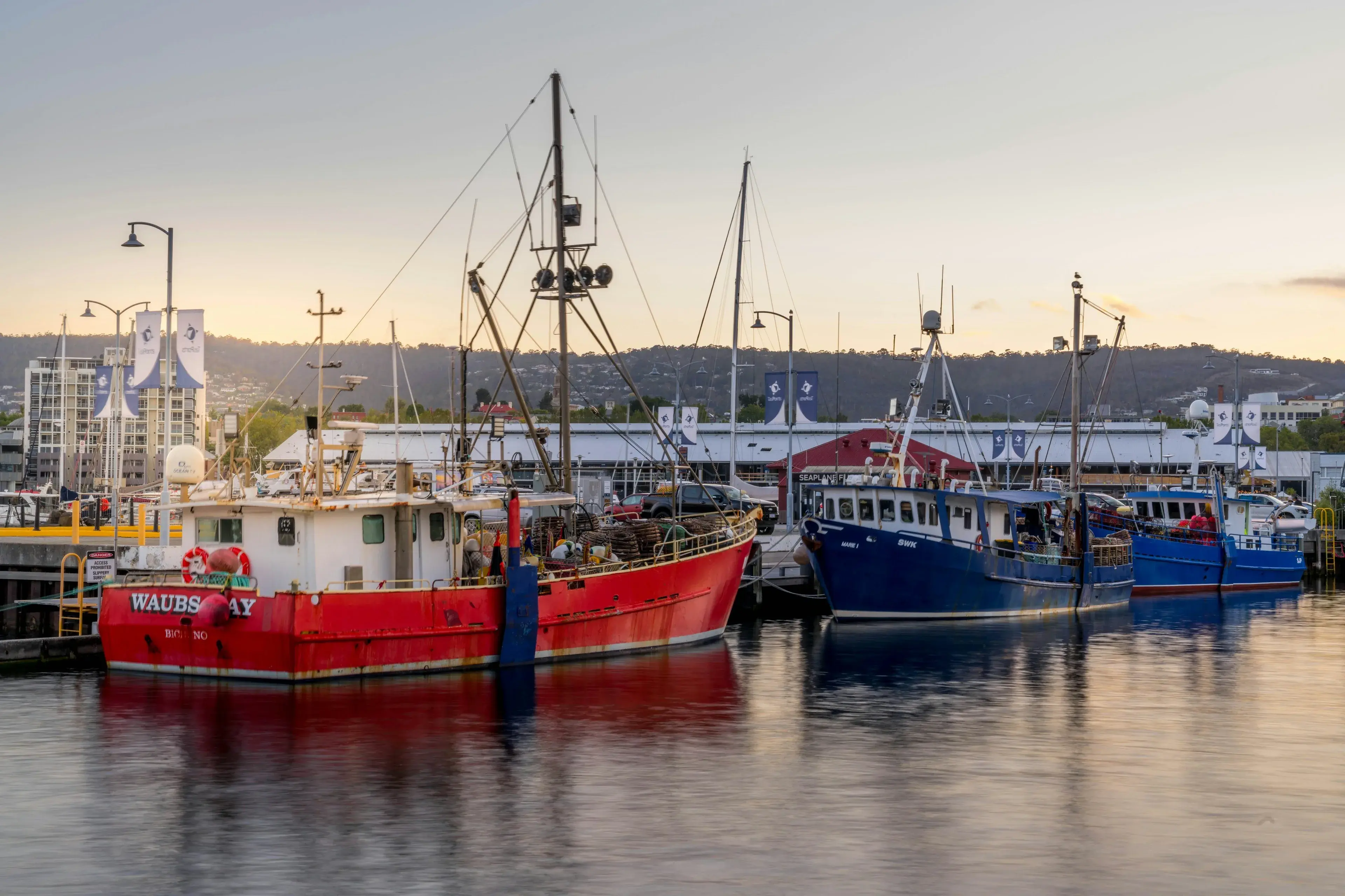 Fishing boats docked on the Hobart waterfront at sunset