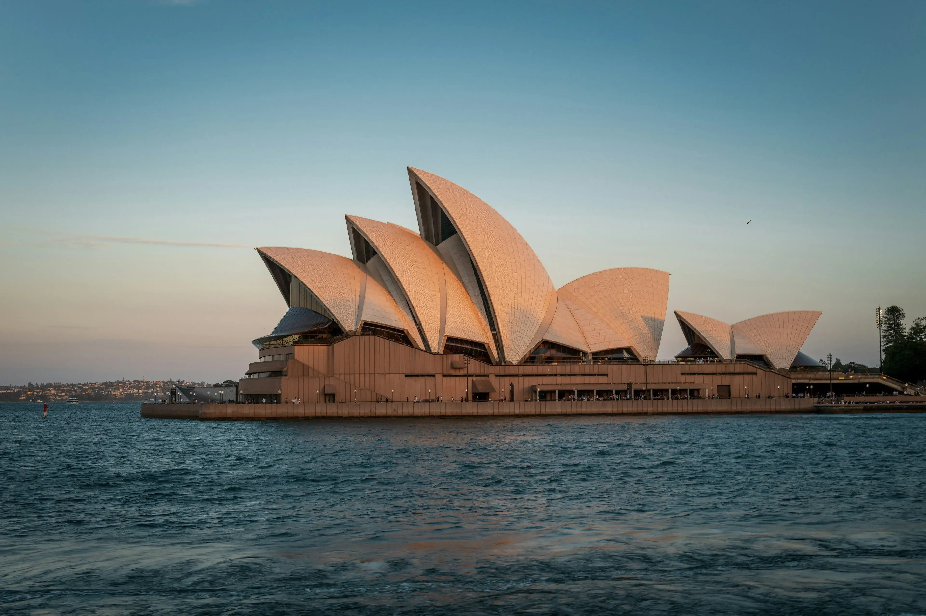 Sydney Opera House at dusk across the harbour