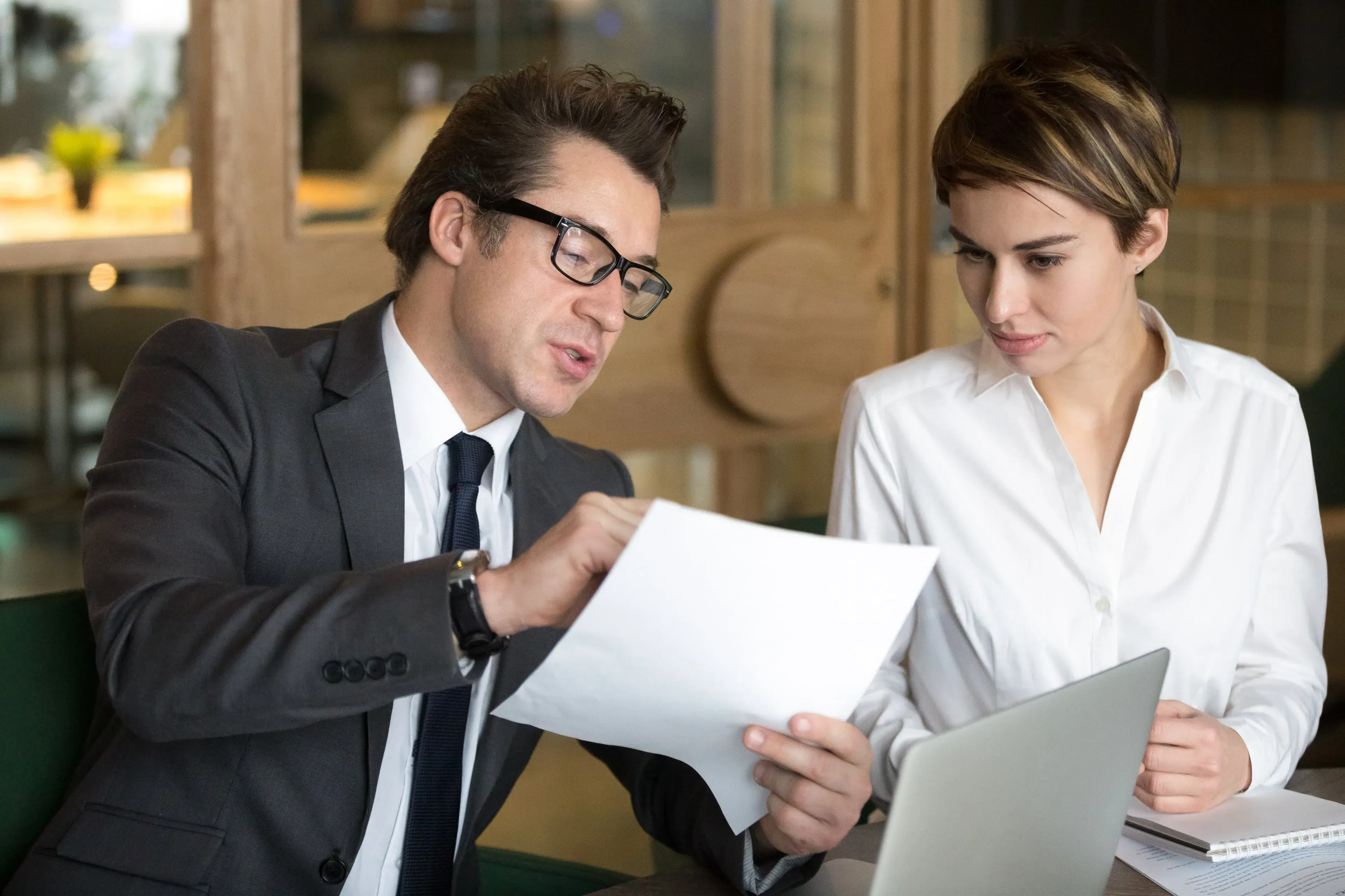 Two professionals reviewing a contract together